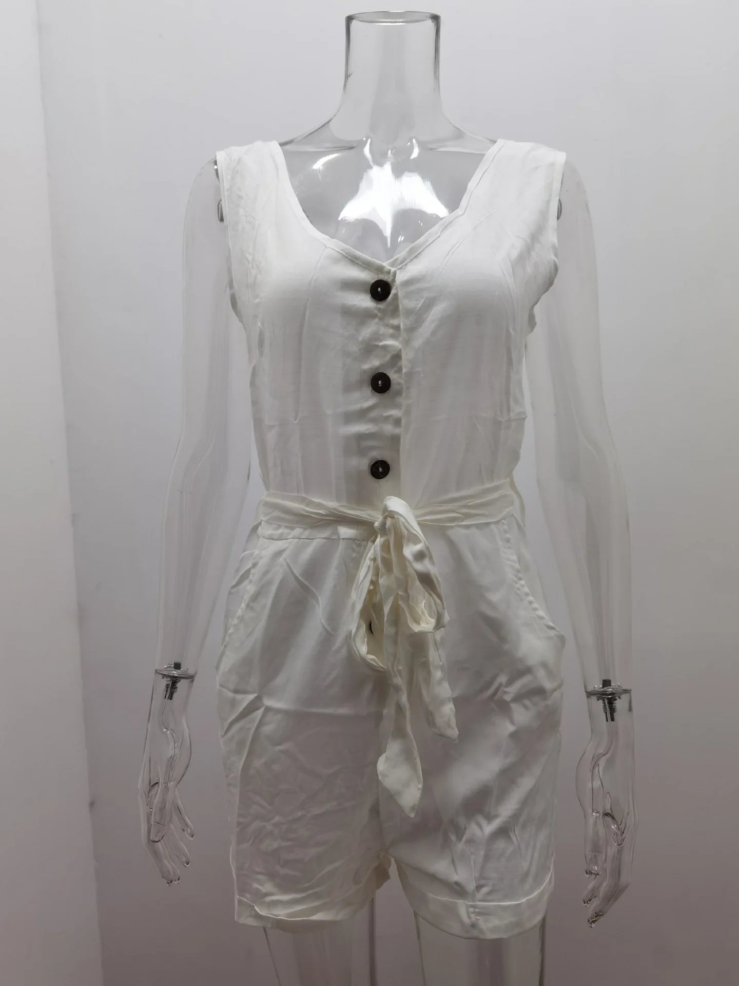 White sleeveless romper on a mannequin against a plain background